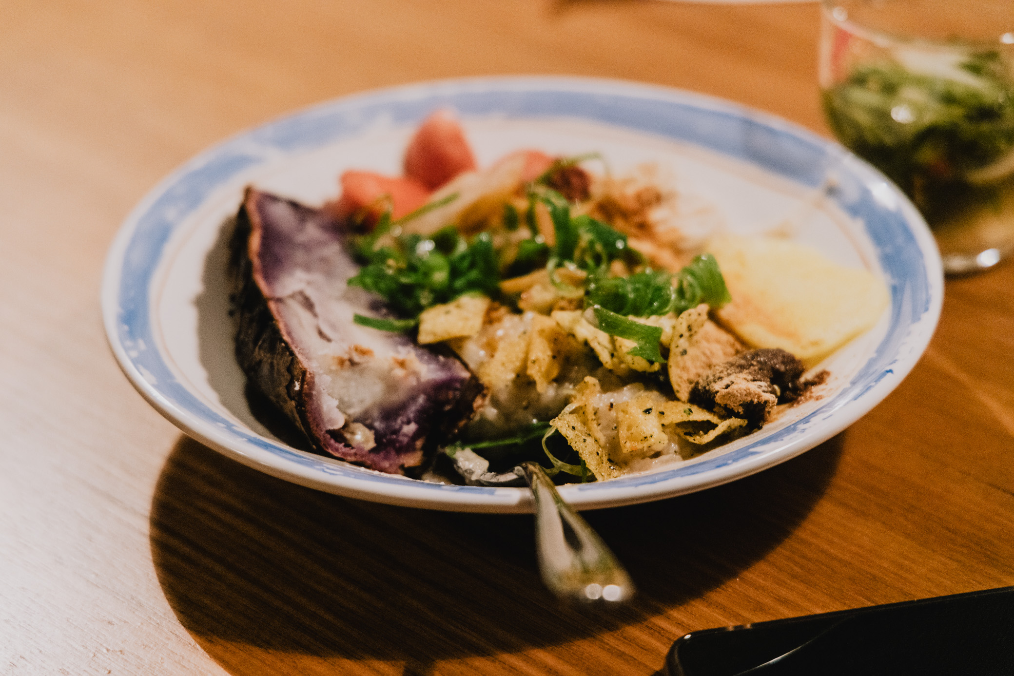 image of a bowl with savoury porridge featuring yam and fermented foods