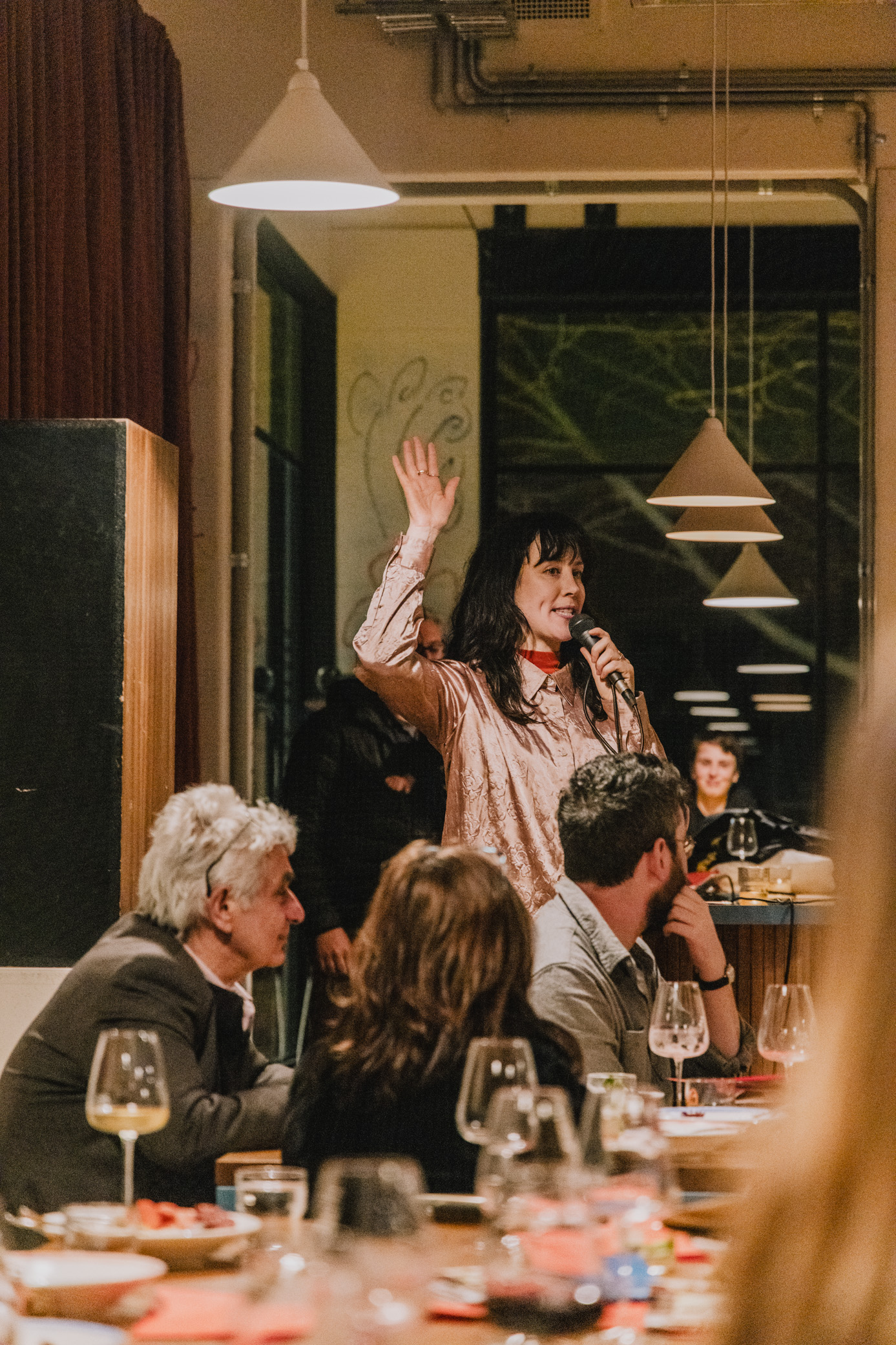 image a person waving their hand at the disorganising dinner